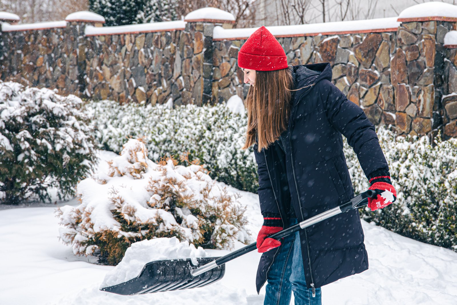 young-woman-cleans-snow-yard-snowy-weather.jpg